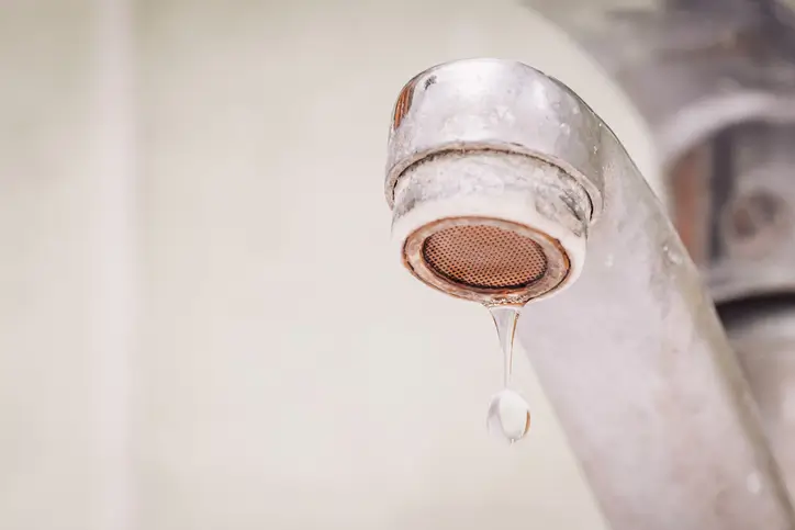 Close up of water dripping from dirty tap in Phoenix