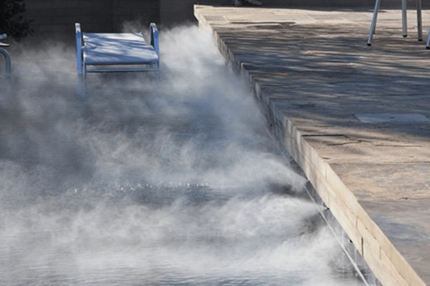 A Misting System Installed Along the Edge of a Swimming Pool