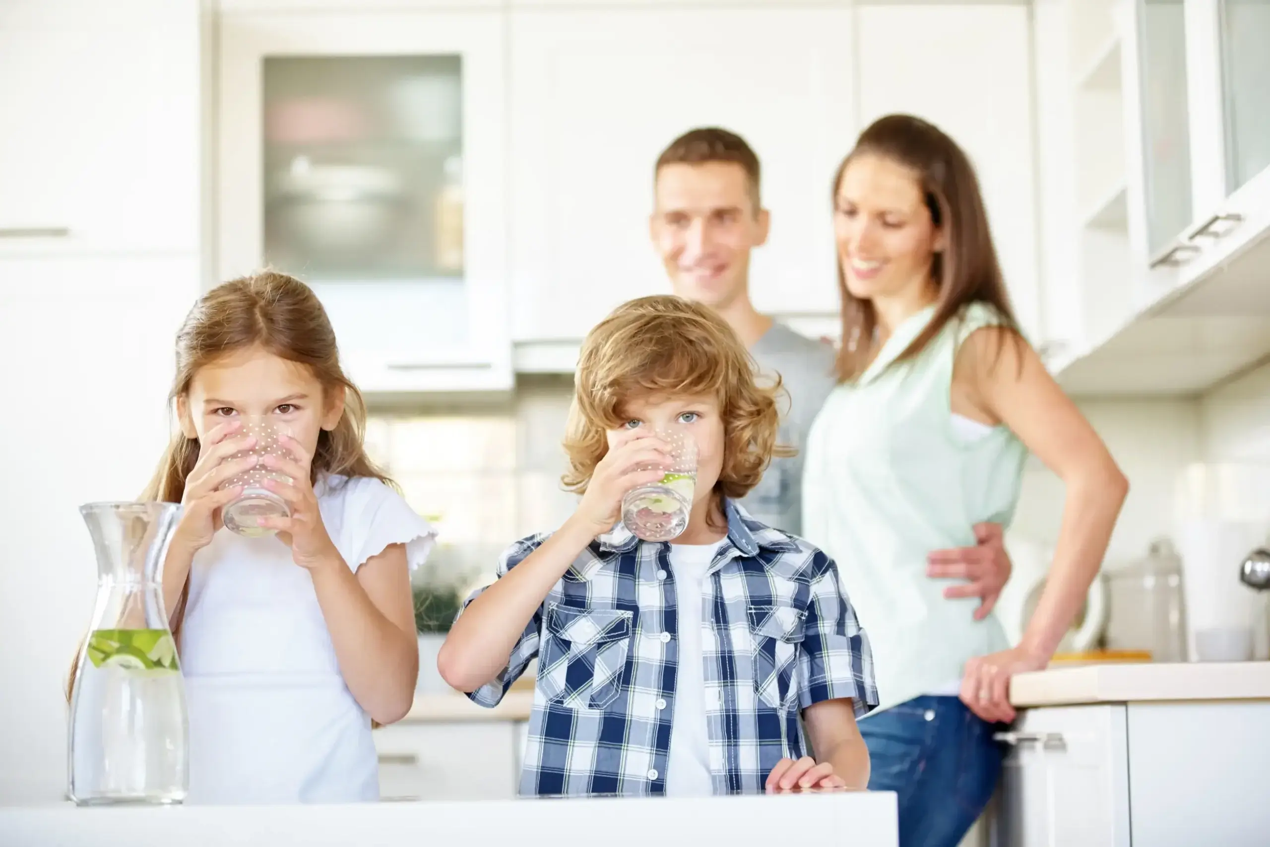 Family drinking fresh tap water in a modern kitchen in Phoenix, AZ
