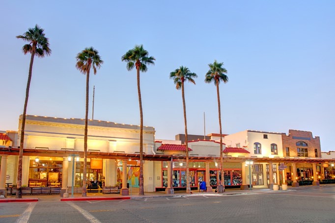 Palm tree-lined shopping district in Chandler, Arizona at sunset