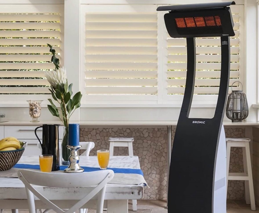 Modern outdoor patio heater warming a cozy dining area with a table set for entertaining