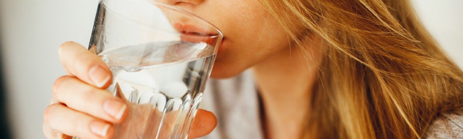 Person drinking glass of Chlorinated Water at home in Phoenix, AZ close-up
